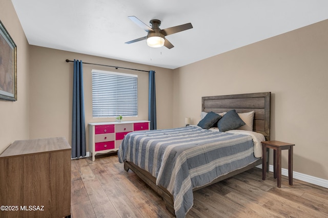 215 E Lester St, Tucson, AZ 85705 - bedroom featuring baseboards, a ceiling fan, and light wood finished floors