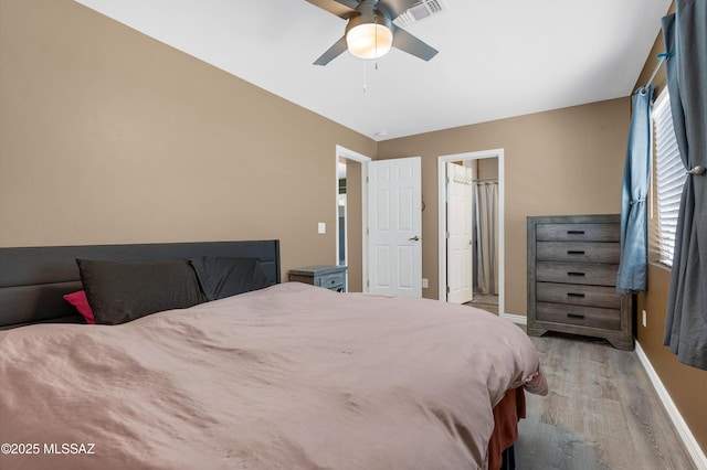 215 E Lester St, Tucson, AZ 85705 - bedroom with a ceiling fan, baseboards, visible vents, and wood finished floors