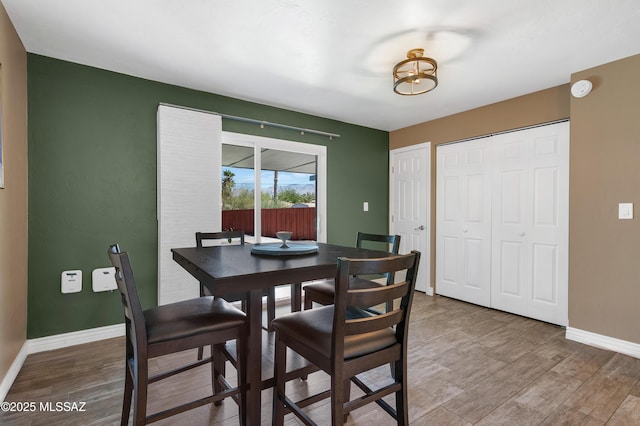 215 E Lester St, Tucson, AZ 85705 - dining area featuring baseboards and light wood finished floors