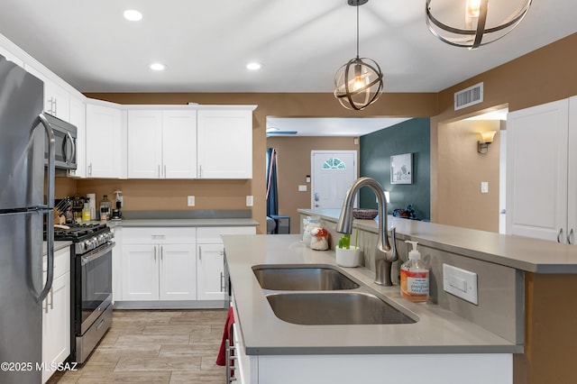 215 E Lester St, Tucson, AZ 85705 - kitchen featuring a sink, white cabinets, stainless steel appliances, and visible vents