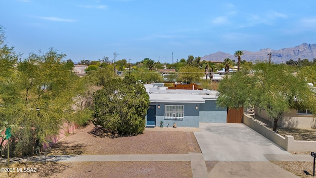 215 E Lester St, Tucson, AZ 85705 - view of front of house featuring a mountain view, stucco siding, and concrete driveway