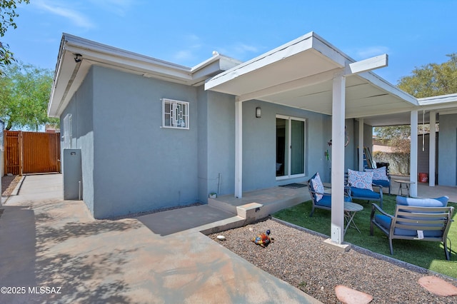 215 E Lester St, Tucson, AZ 85705 - view of front facade featuring a patio area, stucco siding, and fence