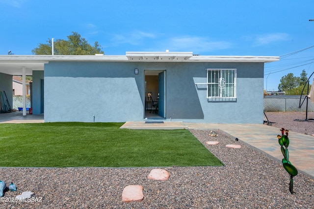 215 E Lester St, Tucson, AZ 85705 - view of front of property with a front lawn, stucco siding, and fence