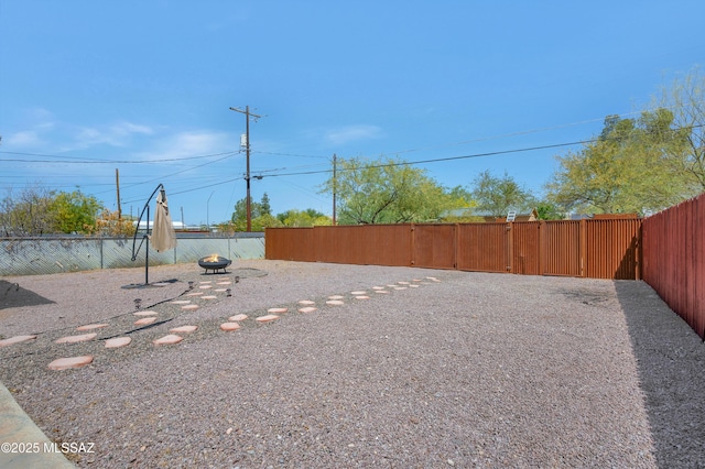 215 E Lester St, Tucson, AZ 85705 - view of yard featuring fence and an outdoor fire pit