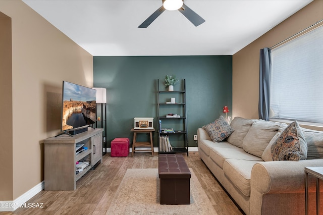 215 E Lester St, Tucson, AZ 85705 - living room featuring light wood-type flooring, a ceiling fan, and baseboards