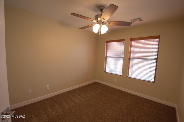 8769 E Green Branch Ln, Tucson, AZ 85730 - empty room with a ceiling fan, baseboards, visible vents, and dark colored carpet