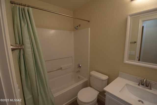 bathroom featuring vanity, shower / bath combo with shower curtain, and toilet