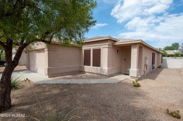 manufactured / mobile home featuring fence and stucco siding