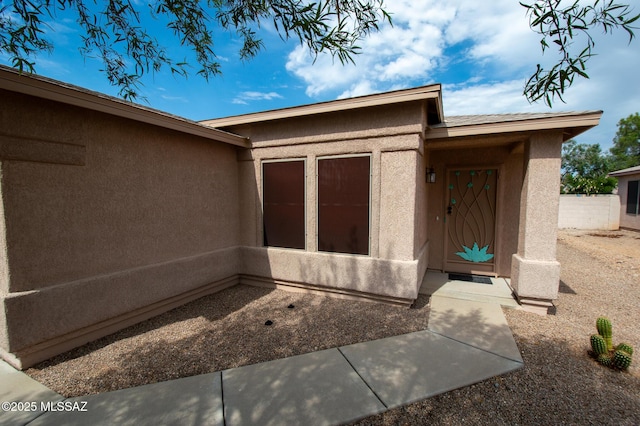 doorway to property with stucco siding
