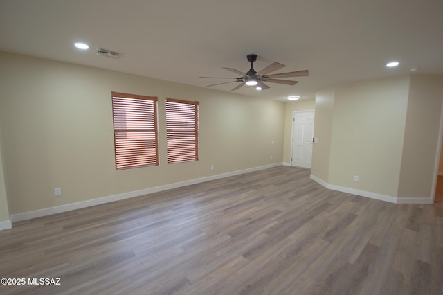 empty room featuring visible vents, a ceiling fan, wood finished floors, and recessed lighting