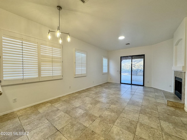 unfurnished living room featuring a tiled fireplace, baseboards, and recessed lighting