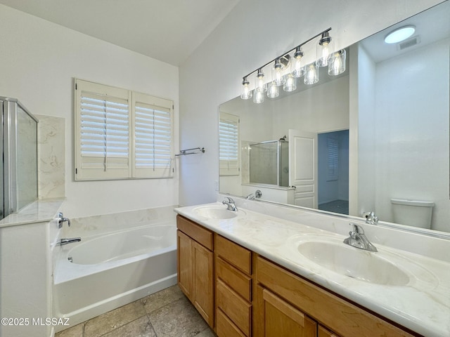 bathroom featuring visible vents, a sink, a garden tub, and a stall shower