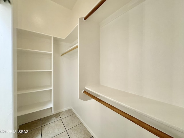 spacious closet with light tile patterned floors