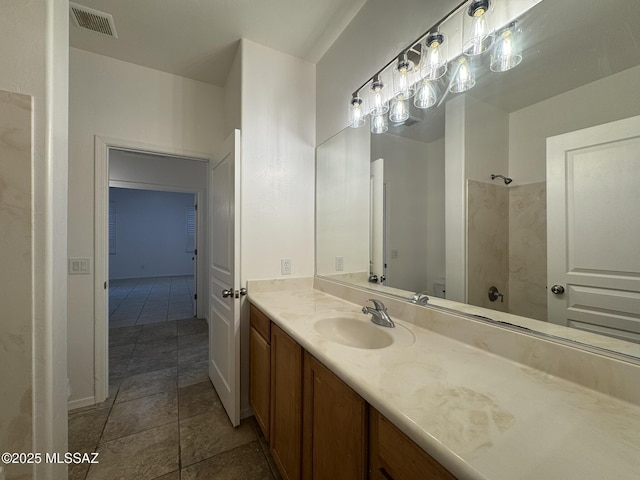 full bathroom featuring vanity, visible vents, and a shower