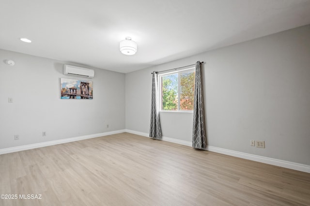 7571 N Rae Ave, Tucson, AZ 85741 - unfurnished room featuring a wall mounted AC, light wood-style flooring, baseboards, recessed lighting, and a smoke detector