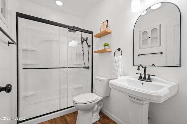 7571 N Rae Ave, Tucson, AZ 85741 - full bathroom featuring a shower stall, wood finished floors, toilet, and baseboards