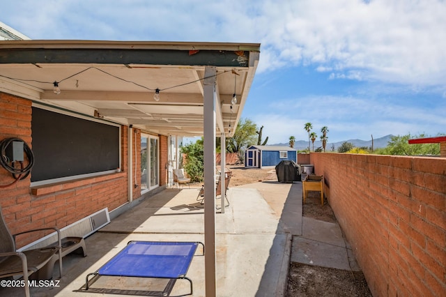 7571 N Rae Ave, Tucson, AZ 85741 - fenced backyard featuring a patio area, a mountain view, and a grill