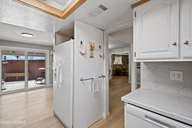 7571 N Rae Ave, Tucson, AZ 85741 - kitchen with white appliances, light wood-style floors, white cabinets, light countertops, and baseboards