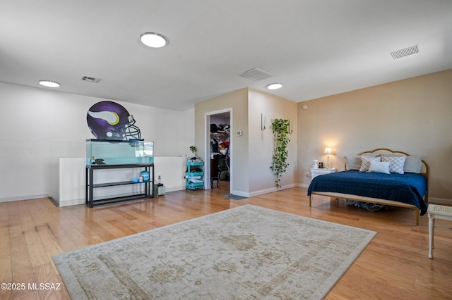 7571 N Rae Ave, Tucson, AZ 85741 - bedroom with wood finished floors, a walk in closet, and baseboards