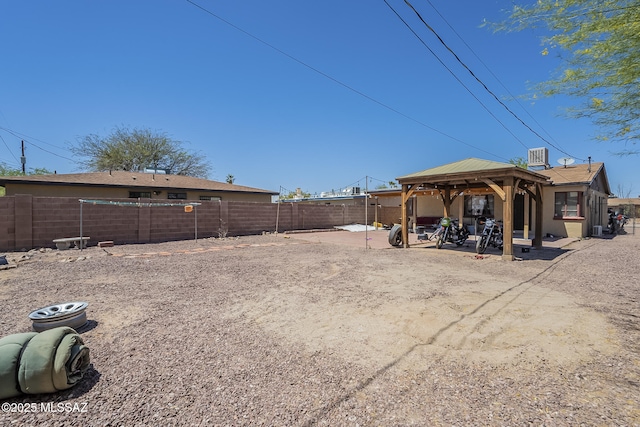 view of yard featuring a fenced backyard, a gazebo, and a patio area