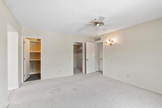 1011 N Placita Yoas, Green Valley, AZ 85614 - unfurnished bedroom featuring a spacious closet, carpet flooring, baseboards, a textured ceiling, and a closet