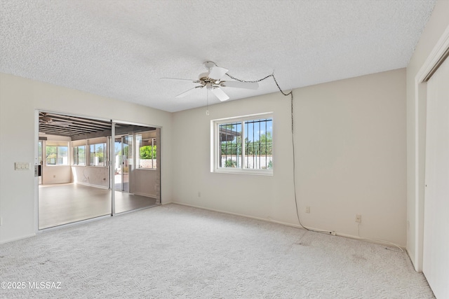 1011 N Placita Yoas, Green Valley, AZ 85614 - unfurnished bedroom featuring access to outside, a textured ceiling, carpet floors, ceiling fan, and baseboards