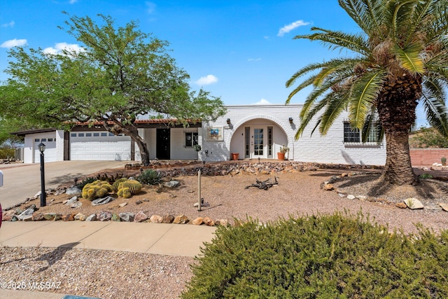 1011 N Placita Yoas, Green Valley, AZ 85614 - view of front of home featuring concrete driveway, a garage, and french doors
