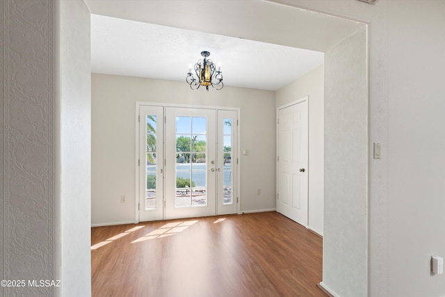 1011 N Placita Yoas, Green Valley, AZ 85614 - foyer with wood finished floors, a chandelier, and baseboards