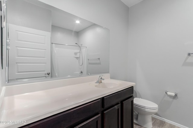 10157 N Sand Sage Trl, Marana, AZ 85653 - bathroom with walk in shower, vanity, toilet, baseboards, and wood finished floors