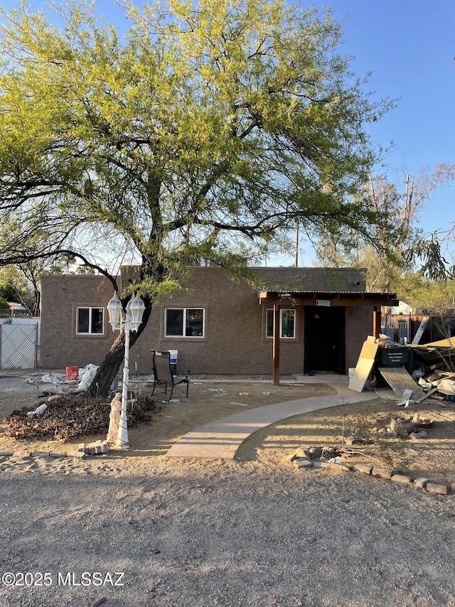 view of front of home featuring fence