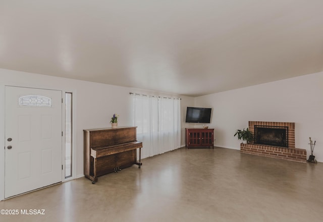 5417 E 3rd St, Tucson, AZ 85711 - living room featuring baseboards, finished concrete floors, and a fireplace