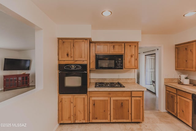 5417 E 3rd St, Tucson, AZ 85711 - kitchen featuring light countertops, brown cabinetry, and black appliances