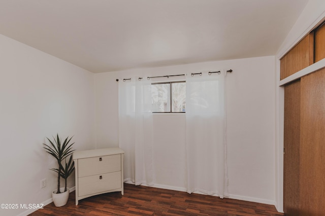 5417 E 3rd St, Tucson, AZ 85711 - unfurnished bedroom featuring baseboards and dark wood-style floors
