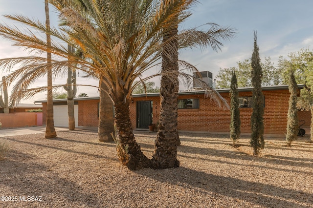 5417 E 3rd St, Tucson, AZ 85711 - view of front of house with brick siding and concrete driveway