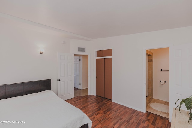 5417 E 3rd St, Tucson, AZ 85711 - bedroom featuring baseboards, visible vents, dark wood finished floors, and a closet