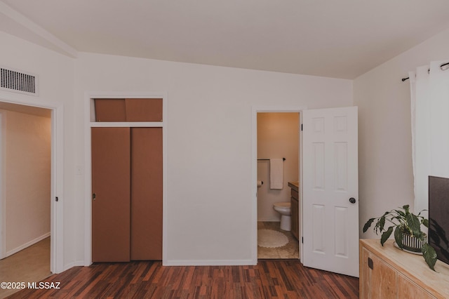 5417 E 3rd St, Tucson, AZ 85711 - unfurnished bedroom featuring visible vents, dark wood finished floors, baseboards, a closet, and ensuite bath