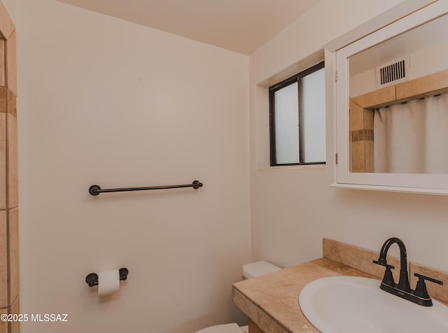 5417 E 3rd St, Tucson, AZ 85711 - full bathroom featuring visible vents, a shower with shower curtain, toilet, and vanity