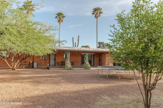 5417 E 3rd St, Tucson, AZ 85711 - back of property featuring a trampoline and brick siding
