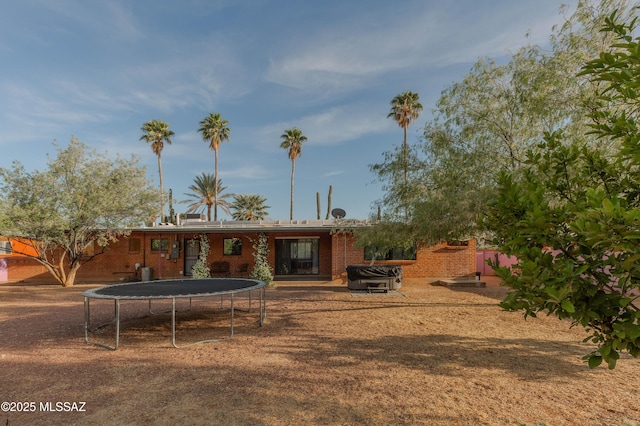 5417 E 3rd St, Tucson, AZ 85711 - back of house featuring brick siding and a trampoline