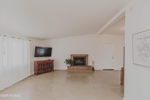 5417 E 3rd St, Tucson, AZ 85711 - living area featuring baseboards, vaulted ceiling with beams, concrete floors, and a fireplace