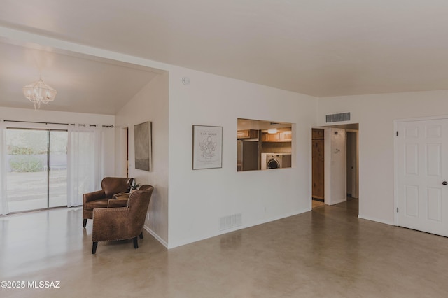 5417 E 3rd St, Tucson, AZ 85711 - living area featuring a notable chandelier, finished concrete floors, washer / dryer, and visible vents