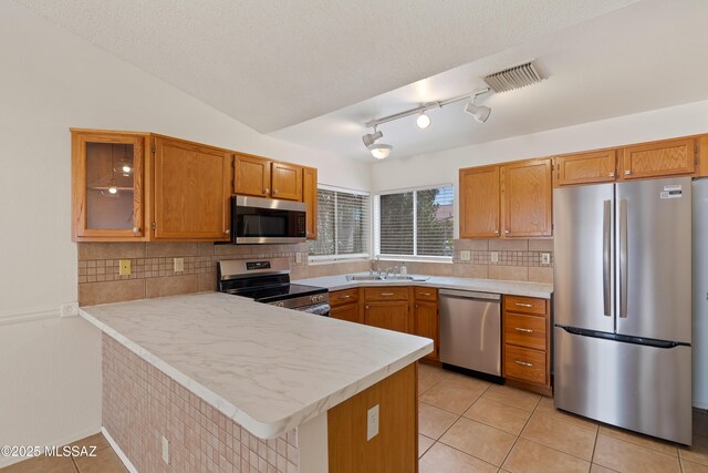 3564 W Sky Ridge Loop, Tucson, AZ 85742 - kitchen featuring stainless steel appliances, a sink, decorative backsplash, and light tile patterned floors