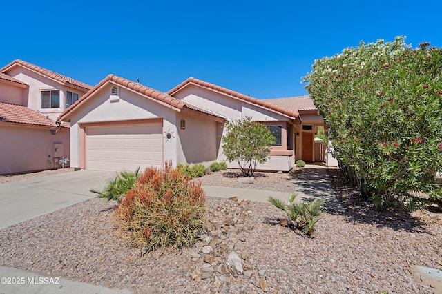 3564 W Sky Ridge Loop, Tucson, AZ 85742 - view of front of house with a garage, concrete driveway, a tile roof, and stucco siding