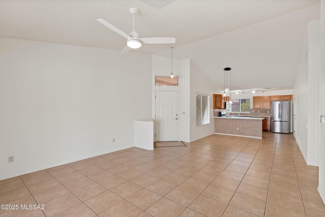 3564 W Sky Ridge Loop, Tucson, AZ 85742 - kitchen featuring stainless steel appliances, light countertops, a peninsula, light tile patterned floors, and lofted ceiling