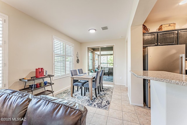 dining space featuring visible vents, baseboards, and light tile patterned floors