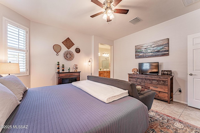 bedroom featuring light tile patterned floors, ceiling fan, connected bathroom, and visible vents
