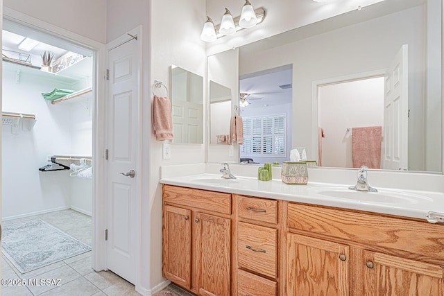 bathroom featuring double vanity, a sink, a ceiling fan, and tile patterned flooring