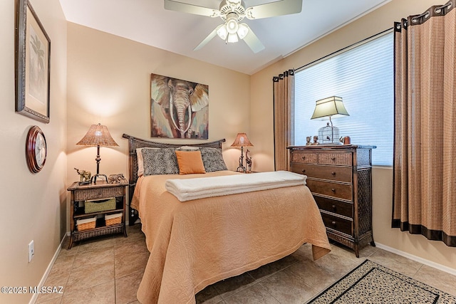 bedroom featuring a ceiling fan, baseboards, and light tile patterned flooring