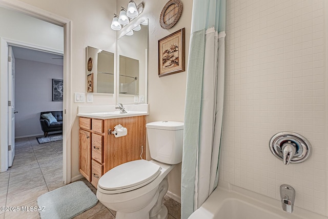 full bathroom with tile patterned flooring, vanity, toilet, baseboards, and shower / bath combo