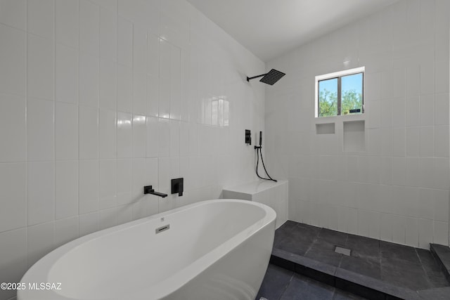 full bath featuring tile walls, a tile shower, and a freestanding bath